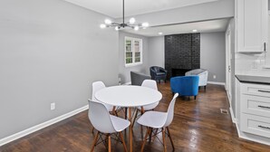 A modern kitchen with white cabinets and a black countertop. - Sleek & Affordable 3 Bedroom/2 Bath in downtown Overland Park! (Overland Park)