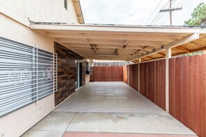 Stroll through the covered corridor to the entrance of this charming building.