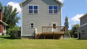 A two-story house with a front deck and a small porch. - Family-friendly home, dedicated workspace, minutes from Cincinnati attractions! (Cincinnati)