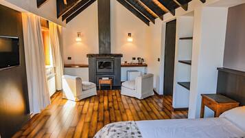 Deluxe Suite | Living area | 32-inch LCD TV with cable channels, fireplace