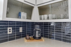 Enjoy cooking in this well-equipped kitchen with a coffee maker and ample workspace.