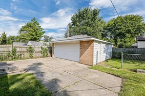 Situated in a backyard, this garage offers a convenient space for parking and storage.
