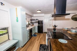 Kitchen equipped with a sink, dishwasher, and range hood.