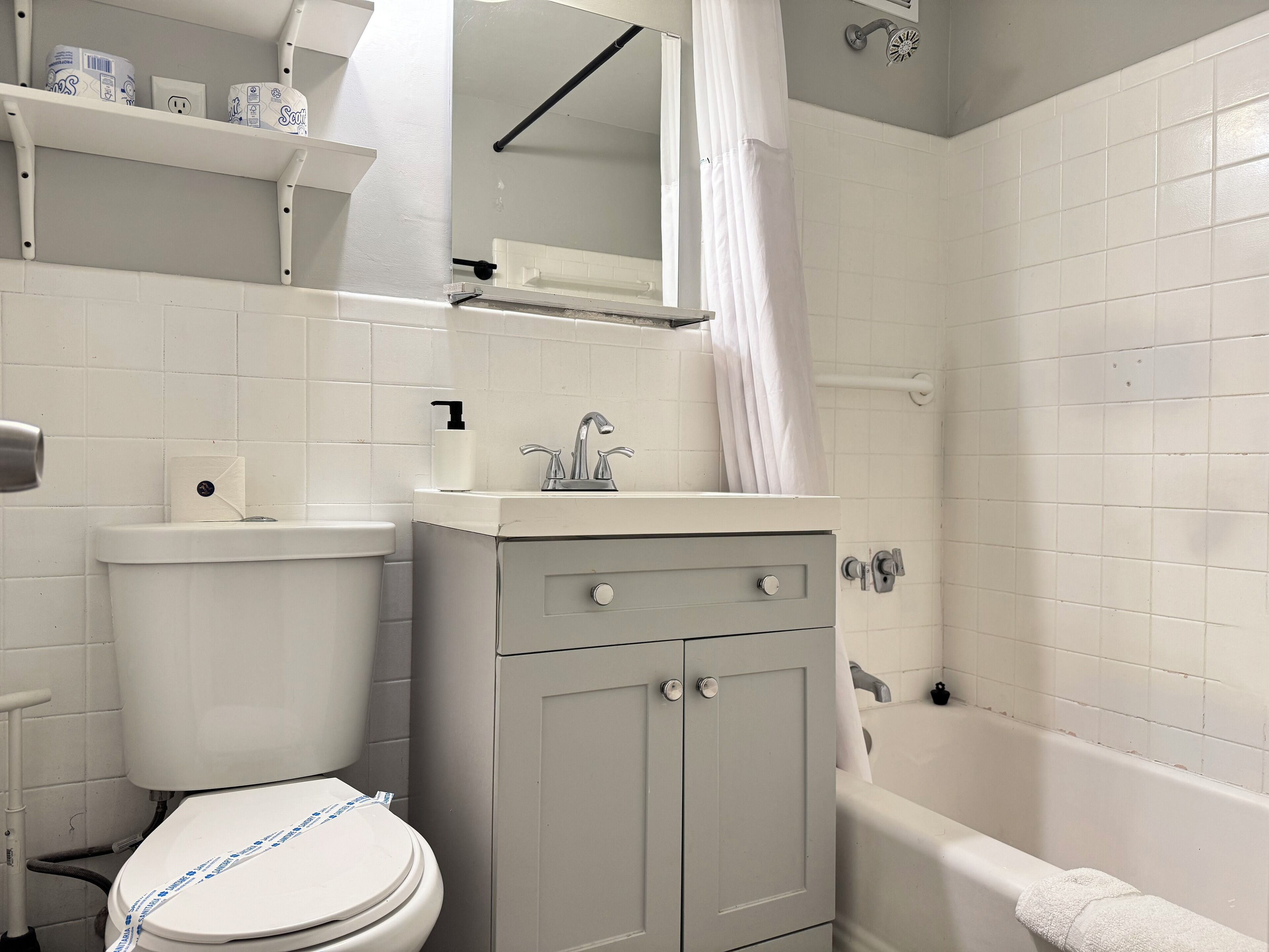 Une salle de bain avec des toilettes, un lavabo et une baignoire.