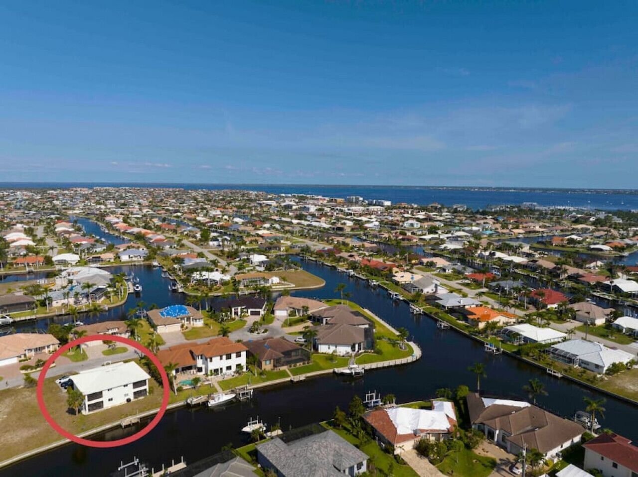 A residential area with a river running through it, surrounded by houses and docks.