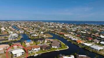 A residential area with a river running through it, surrounded by houses and docks.