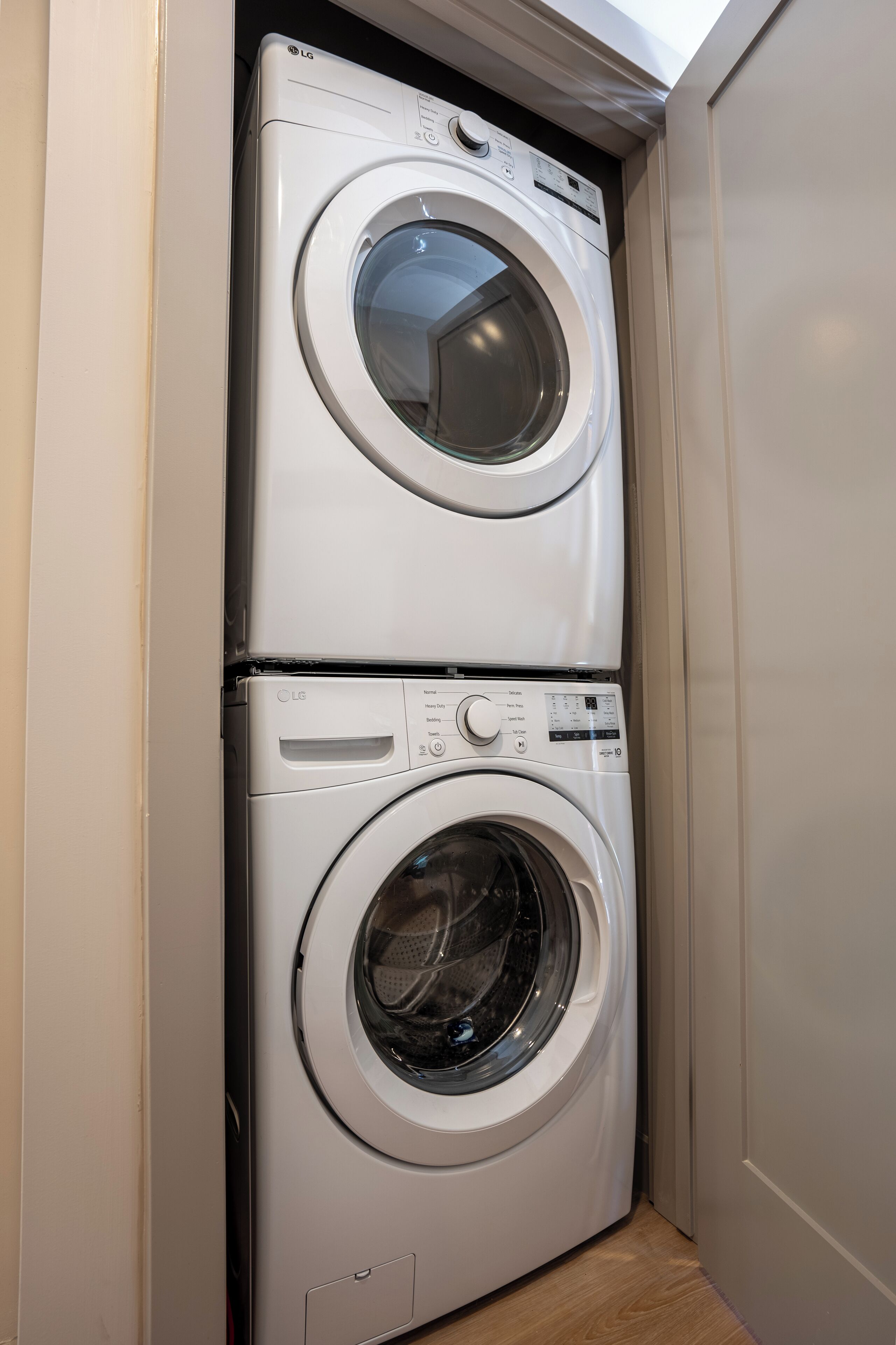 A compact laundry room with two stacked washing machines.