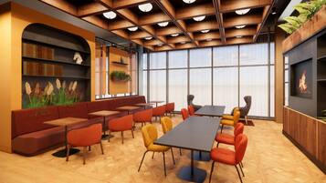 A modern interior with a long table, multiple chairs, a sofa, and a bookshelf.
