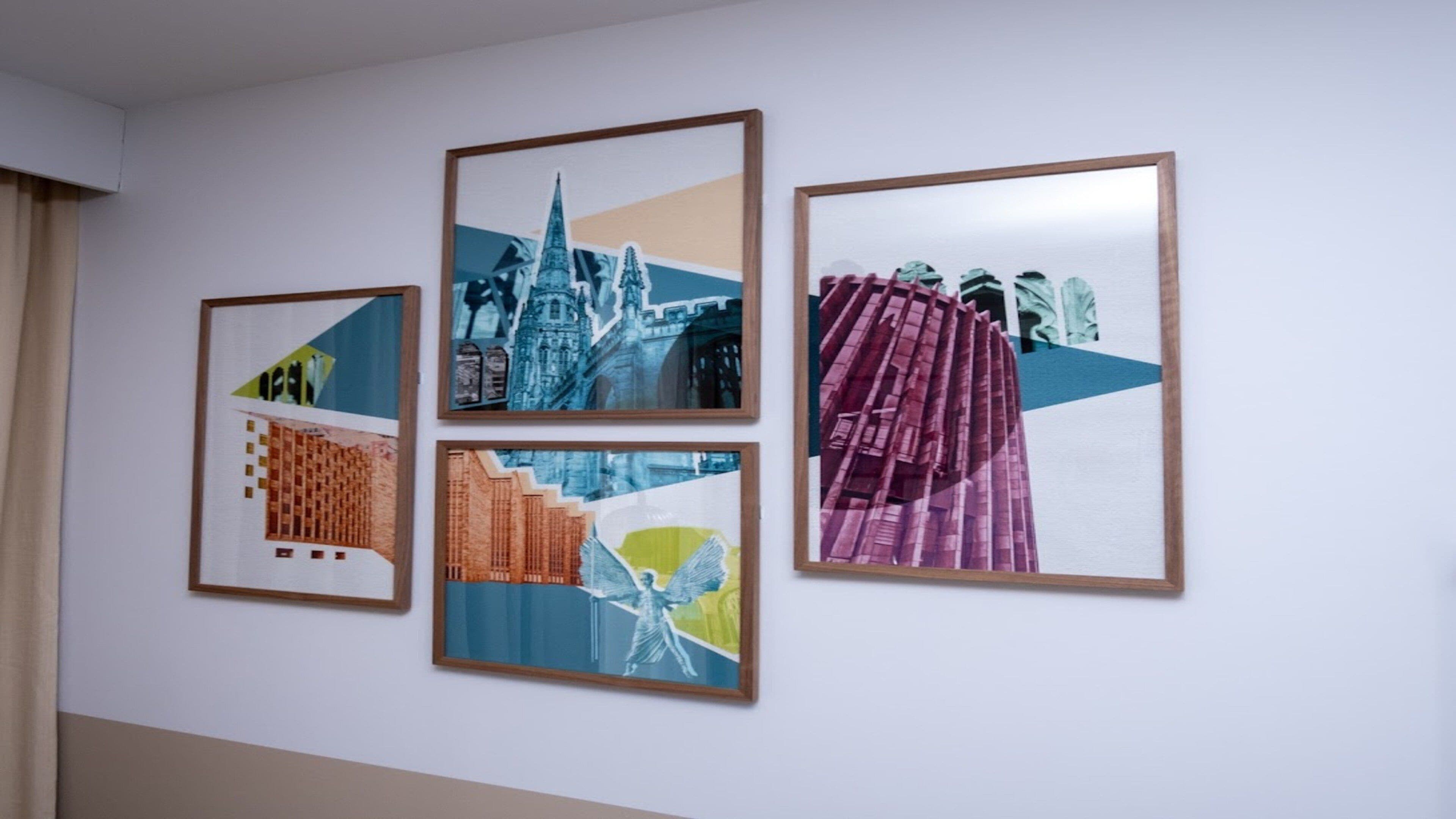 Four framed artworks on a wall.