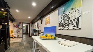 A modern kitchen with a white countertop, a bowl of lemons, and a notebook.
