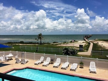 Large pool w/view! Sidewalk to our lighted fishing pier. View from our balcony