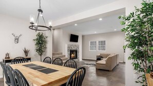 A spacious living area with a fireplace, a dining table with chairs, and a sofa. - Center Hill Serenity (Silver Point)