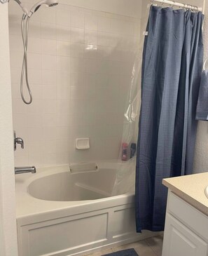 A bathroom with a bathtub, a shower, and a toilet. - Disney Area - Heated Pool - 3 Bedroom Townhome (Kissimmee)