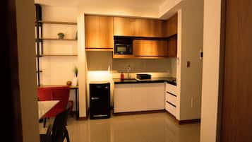 Fridge, microwave, coffee/tea maker, cookware/dishes/utensils