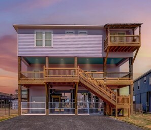 A multi-story building with a balcony and a staircase.