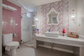 A bathroom with a glass shower, a white sink with a marble backsplash, and a vanity mirror. - The star of sathon Luxury king room 502 (Krung Thep Maha Nakhon)