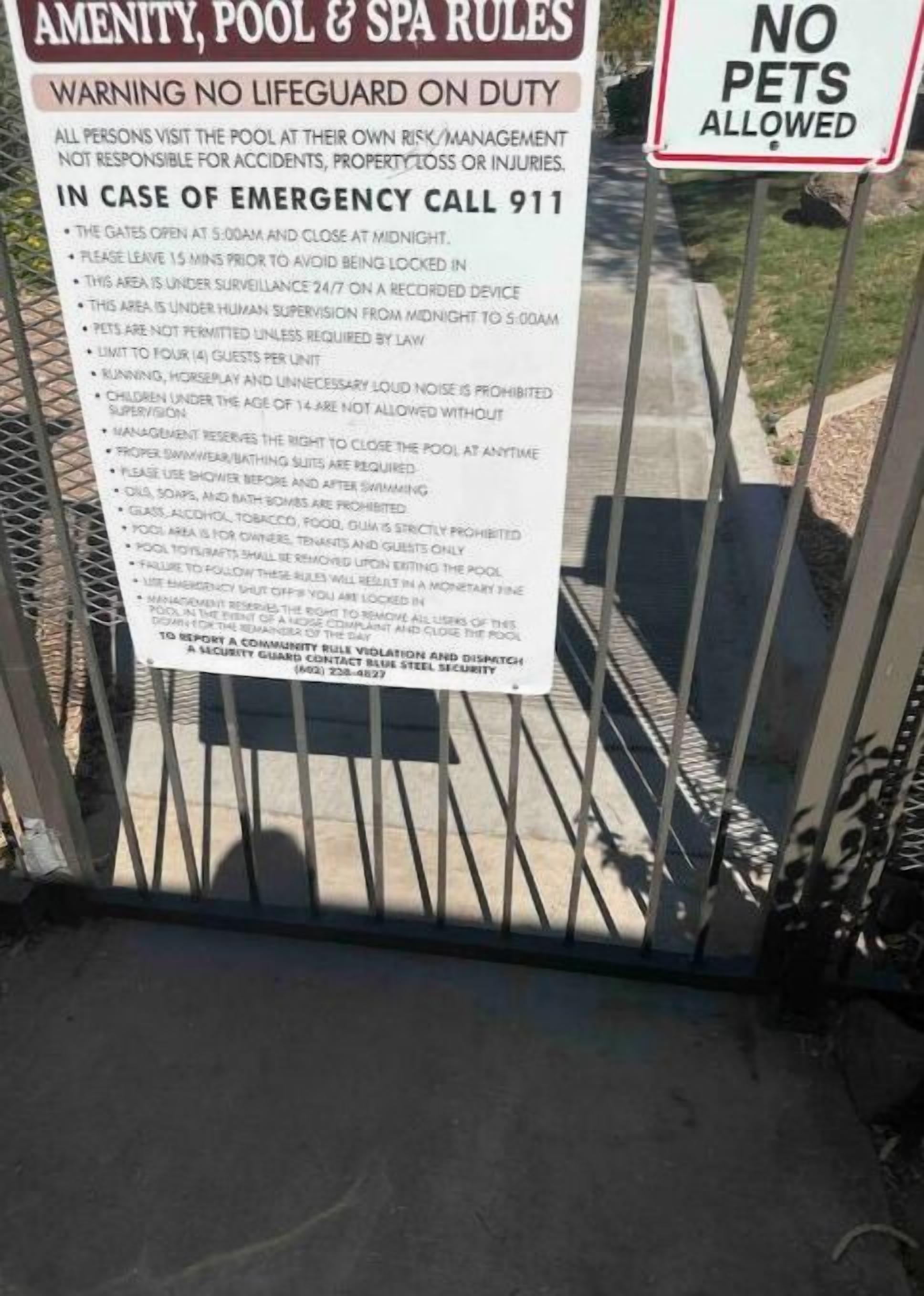 A sign listing pool and spa rules, including no pets allowed and emergency contact information.