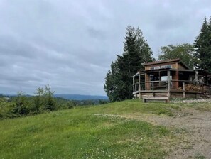 Guests can enjoy a tranquil retreat in this cabin-style building, surrounded by lush greenery and a balcony.