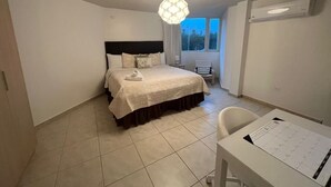 A bedroom with a bed, a desk, and a window. - Paradise in Rio Grande, Puerto Rico Right Next door to Four Seasons (Río Grande)