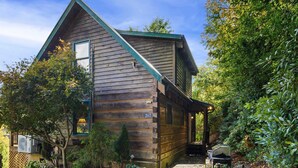 A wooden cabin with a sloped roof, a number '267' on the side, and a covered porch area. - Delightful Cabin near Blue Ridge Mountains (Blowing Rock)
