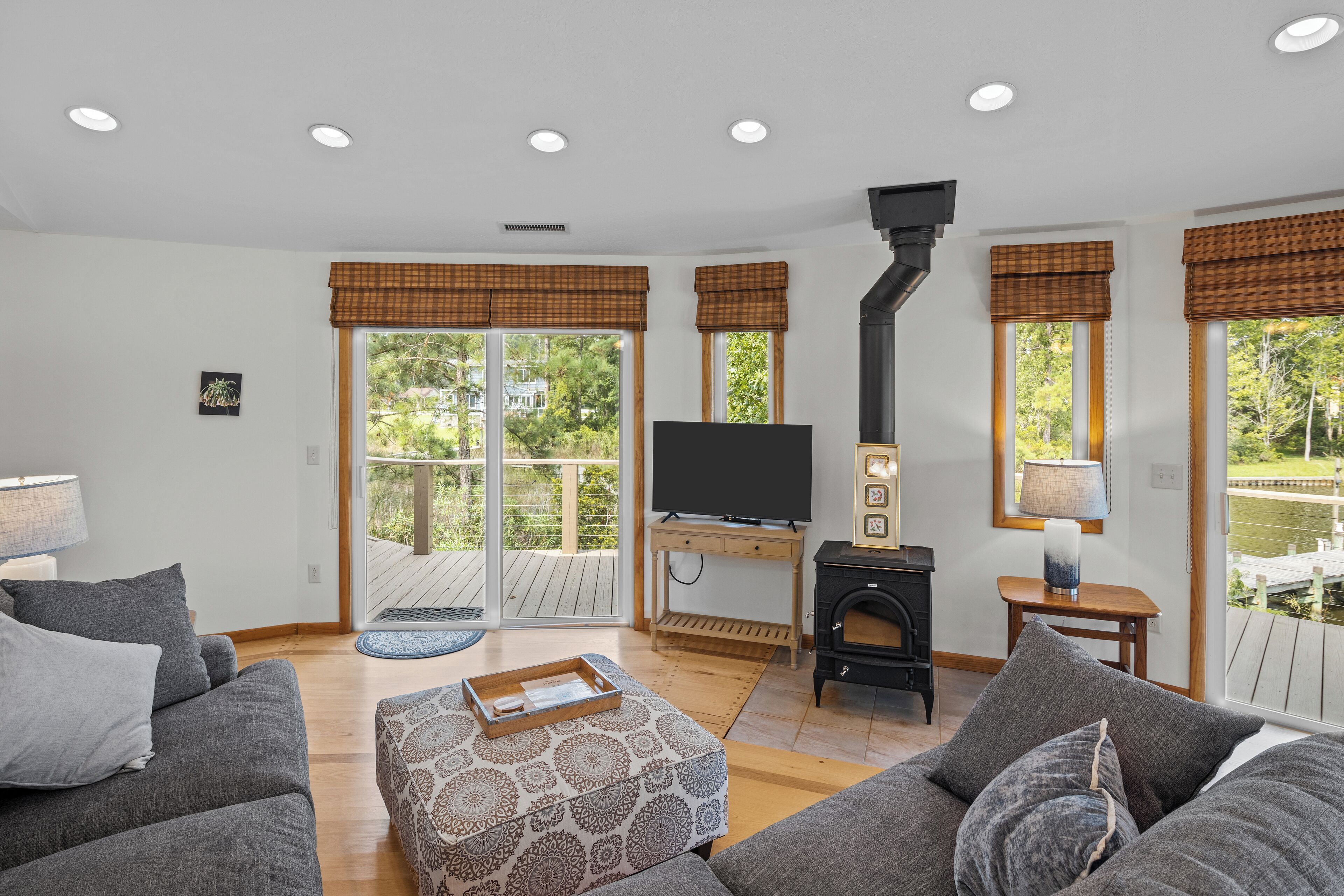 A modern living room with a fireplace, a television, and a sofa.
