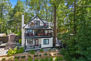 Escape to a serene forest retreat with a cozy chimney and balcony.
