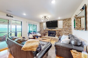 Relax in this stylish living room with a fireplace, flat-screen TV, and comfortable leather sofas.