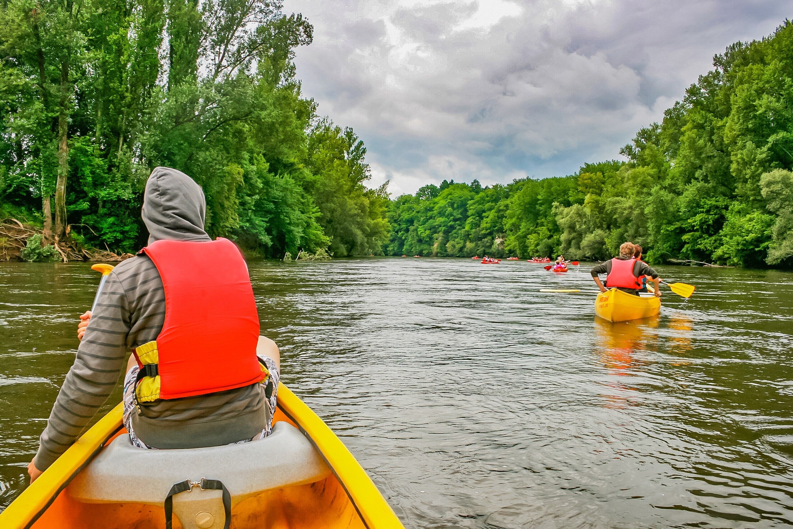 A river scene with canoes and kayaks.