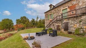 A stone building with a stone staircase, outdoor seating, and a grassy yard. - Holiday Home 'La Dordogne En Périgord' with Private Pool, Private Terrace and Wi-Fi (Salagnac)