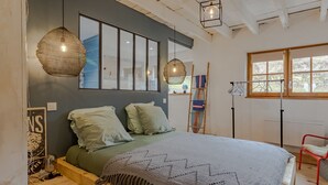 A bedroom with a bed, hanging light fixtures, a window, and a radiator. - Holiday Home 'La Dordogne En Périgord' with Private Pool, Private Terrace and Wi-Fi (Salagnac)