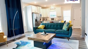 A modern living room with a coffee table, sofa, and a large window.