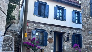 A stone building with a sign for 'Domatia Stone Hotel'. - Domatia Stone Hotel (Soke)