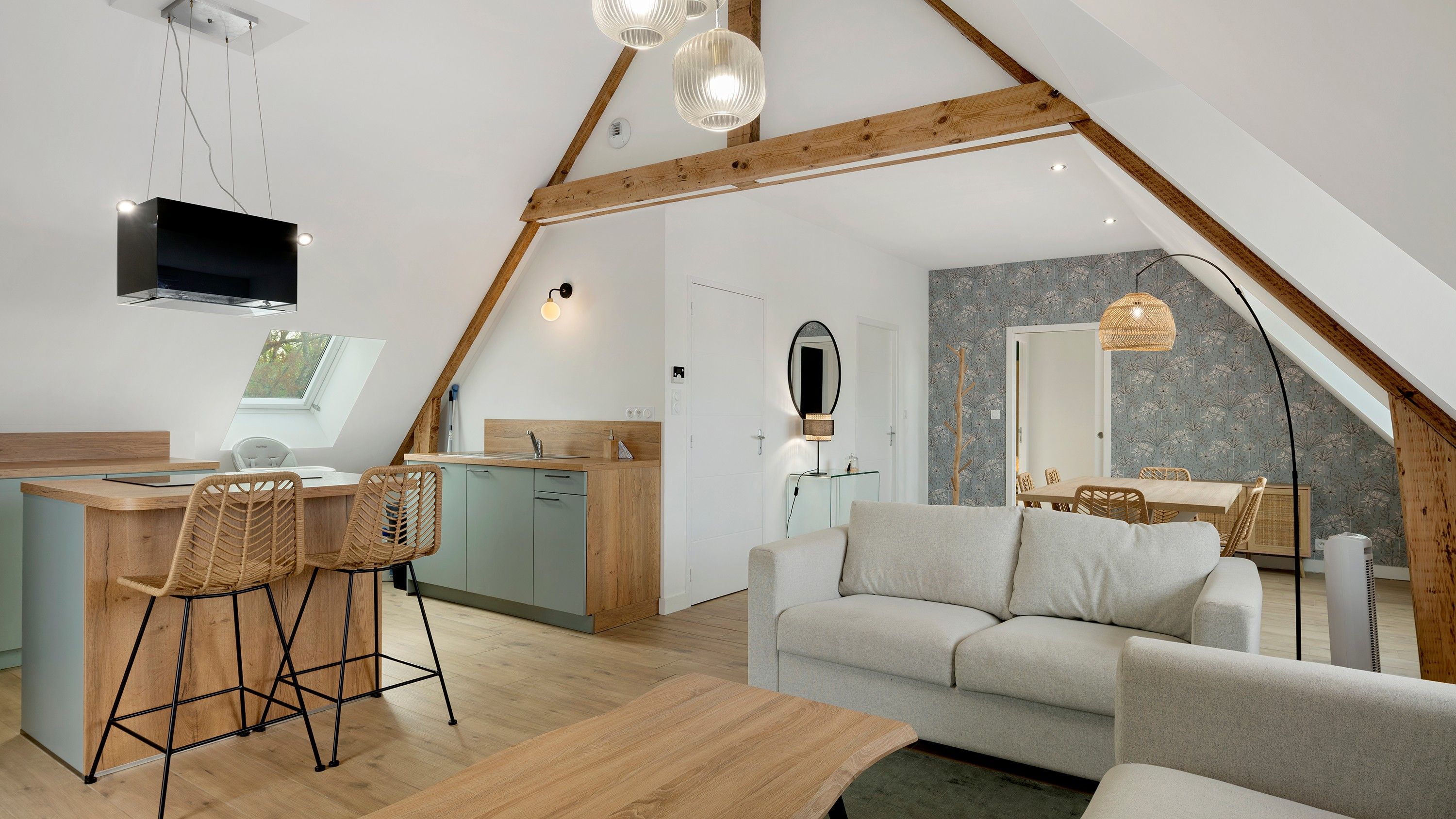 A loft-style living space with a kitchen, dining area, and seating area.