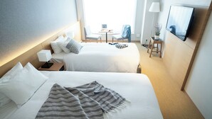A hotel room with two beds, a desk, a chair, a TV, and a window with a view. - KABIN Taka (Kyoto)