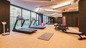 A modern gym with treadmills, a rowing machine, and exercise balls. - KABIN Taka (Kyoto)