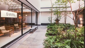 A modern indoor garden with seating and a sign reading "SWRL". - KABIN Taka (Kyoto)