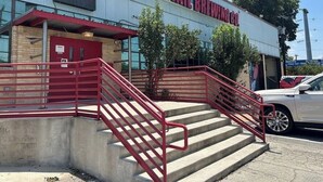 A building with a sign reading "Freetail Brewing Co." and a red staircase leading to the entrance.