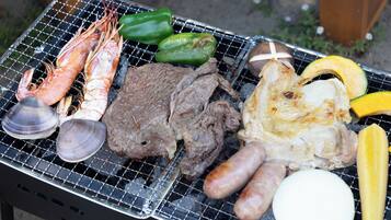A grill with various meats and vegetables.
