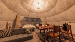 A cozy, tent-like interior with a sofa, dining table, chairs, and a bed. - Innosense Resort -In Chiba Resol- (Sanmu)