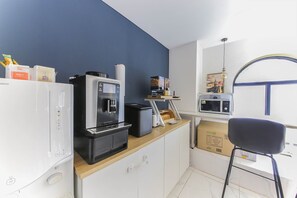 A kitchenette with a coffee machine, microwave, and a small refrigerator. - ND.1226 Hotel (Busan)
