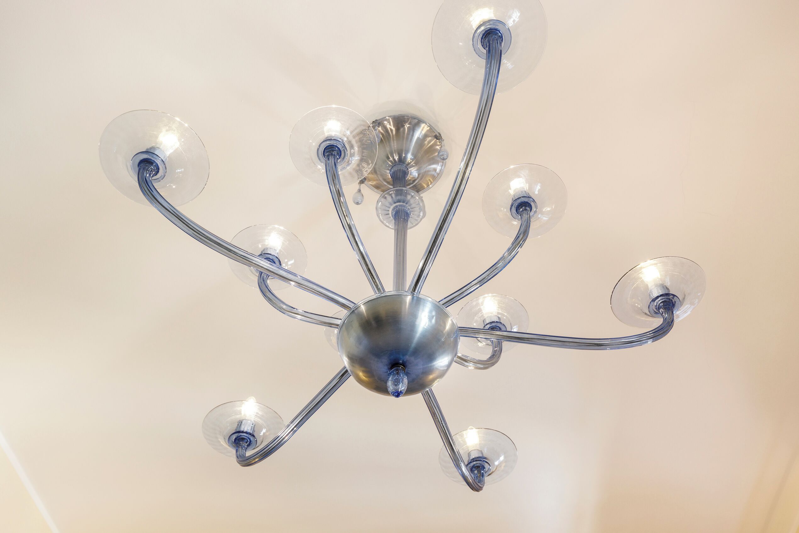 A chandelier with multiple arms and clear glass bulbs.