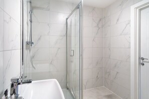 Shower, hair dryer, towels, shampoo