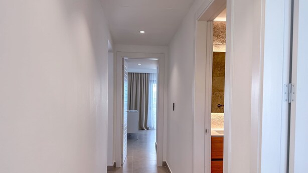 A hallway with a door leading to a bathroom. - Luxury 3 bedroom Apartment at the beach (Punta Cana)