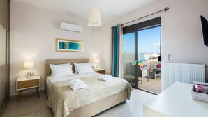 A modern hotel room with a large bed, a balcony with a view, and a flat-screen TV mounted on the wall. - Peris 2 Luxury Villa In Chania, Private Pool (Daratsos)