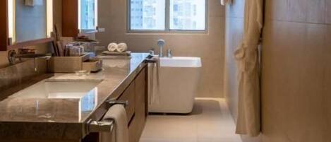 A modern bathroom with a large mirror, a bathtub, and a sink.