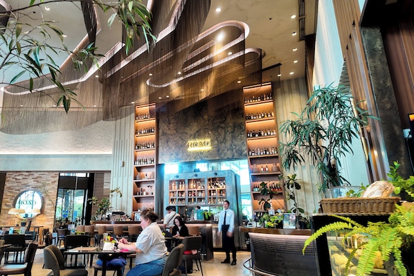 A spacious indoor area with seating, a bar area with shelves of bottles, and a prominent sign reading 'ROAD'.