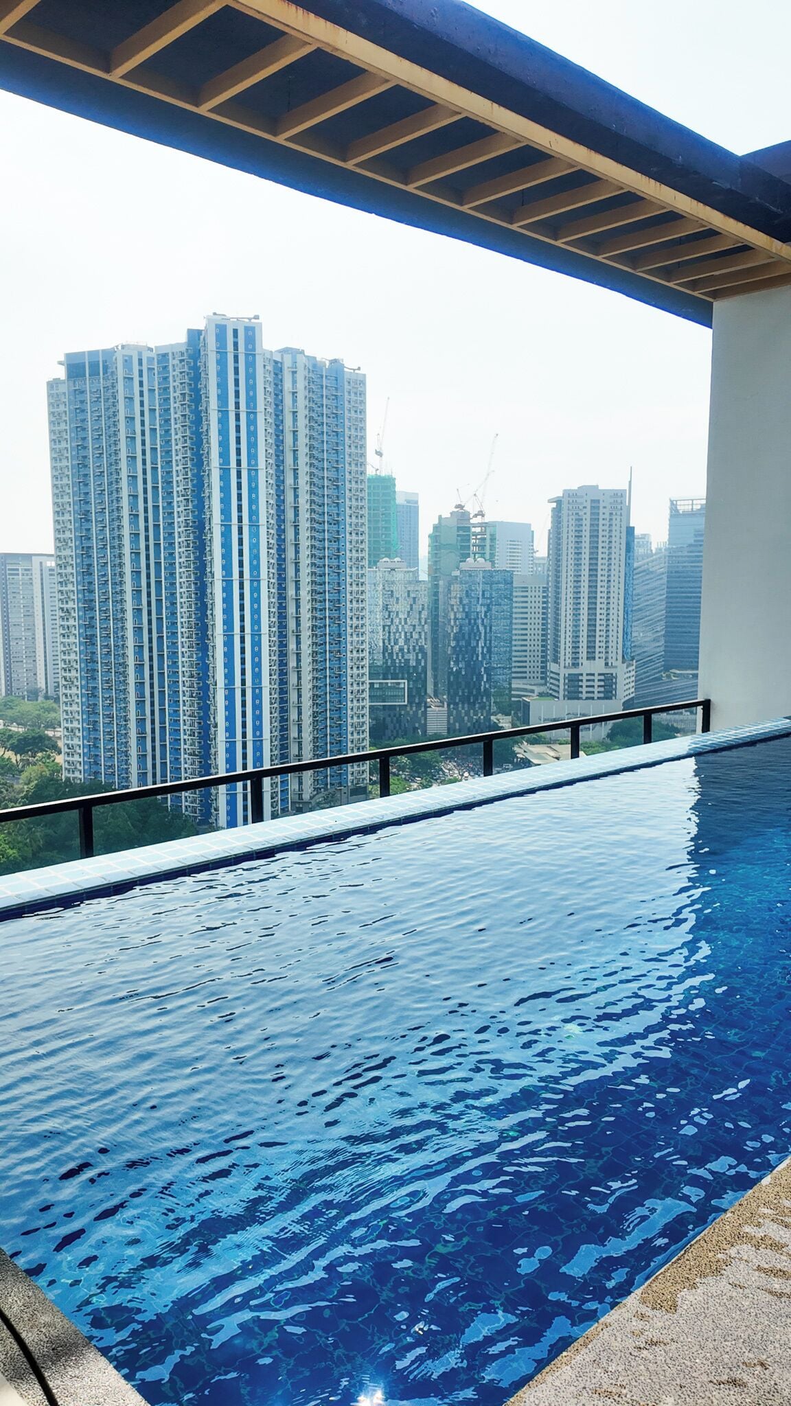 A swimming pool with a view of high-rise buildings in the background.