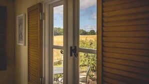 Eine Holztür mit Blick auf einen Außenbereich, einschließlich Tisch und Stühlen.