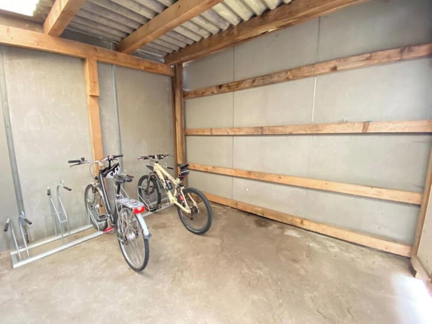 A garage with two bicycles parked inside.