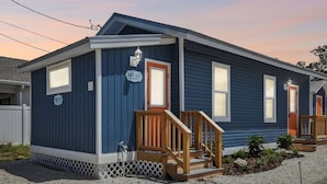 A single-story house with a dark blue exterior, a front porch with wooden steps, and a mailbox. - Downtown Dunedin Hideaway / Easy Walk to Downtown! (Dunedin)